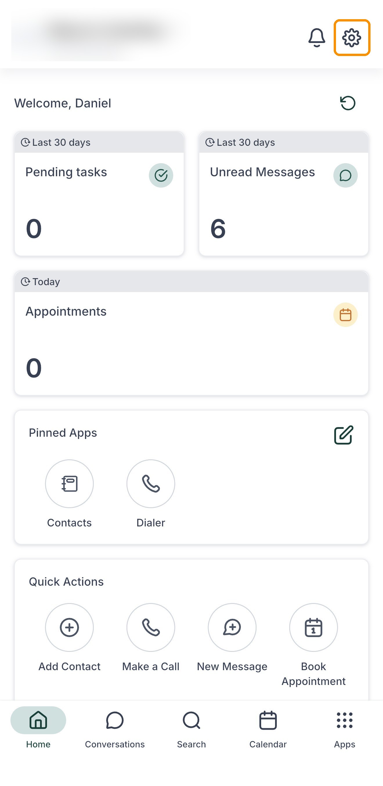 The app home screen with the gear icon marked at the top right